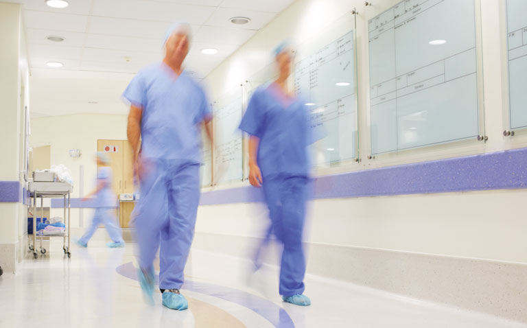 Surgeons walking in hospital corridor