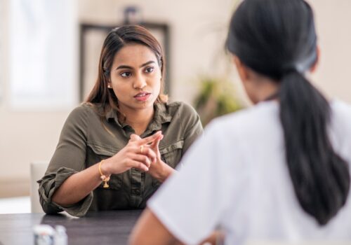 A young woman talking to a healthcare professional