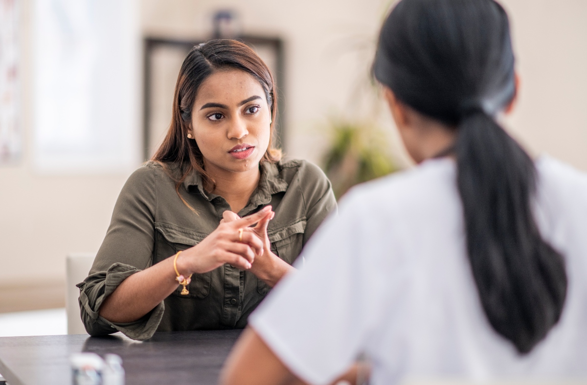 A young woman talking to a healthcare professional