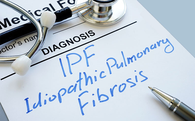 Medical form showing a handwritten diagnosis of idiopathic pulmonary fibrosis (IPF)