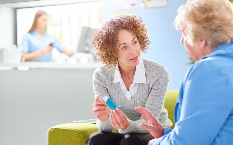 Healthcare professional discussing inhaler options with an older patient in a clinical setting to illustrate aligning patient-centred care and sustainability in inhaler choice