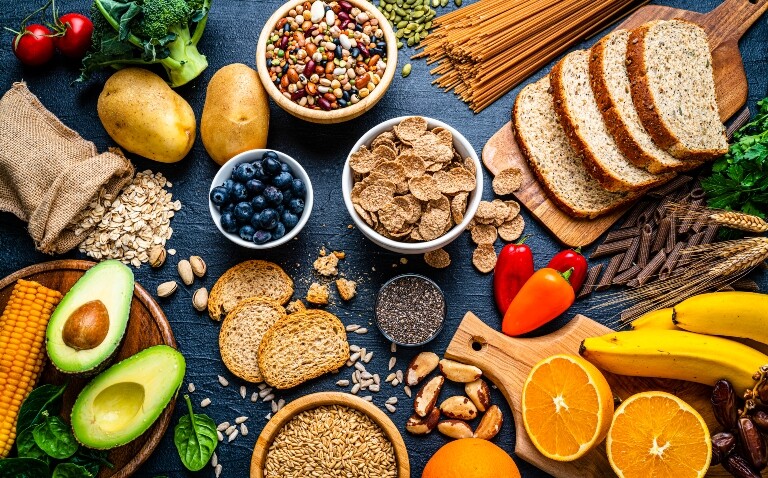 Overhead view of a large group of healthy food including fruit