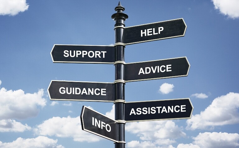A signpost on a background of blue sky and clouds with arrows for help