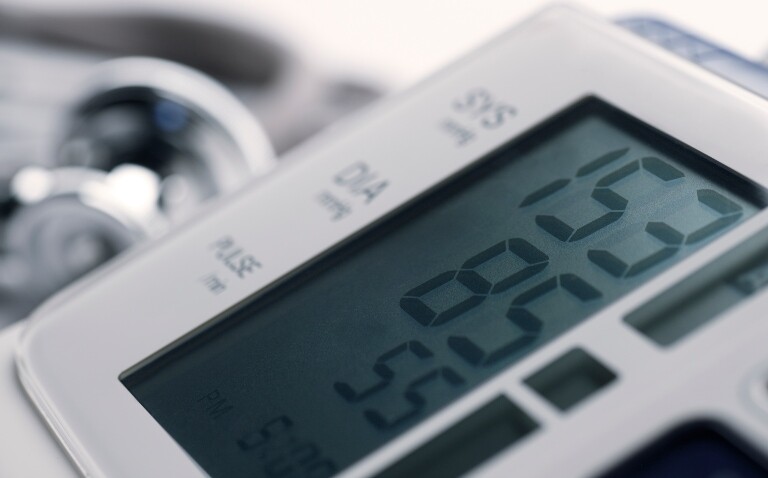 A close up of a blood pressure monitor showing a reading of 153 over 85 to illustrate new research that confirms hypertension prescribing decisions should be based on ethnicity