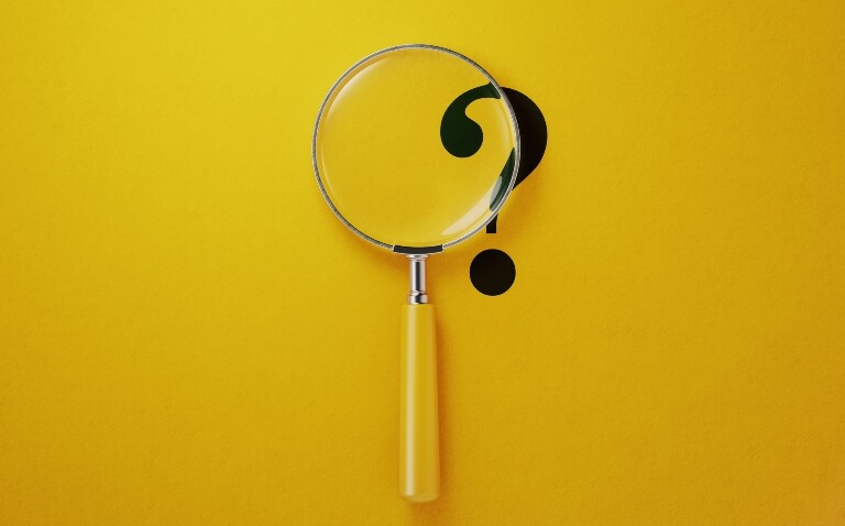 A black question mark on a yellow background with a yellow-handled magnifying glass over the top to illustrate new research identifying diagnosis delays and treatment gaps in psoriatic arthritis