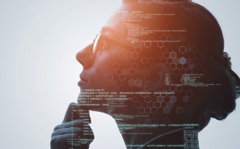 A close up of a woman's side profile with her hand on her chin and computer coding and hexagon shapes overlayed with a burst of brightness over her forehead to illustrate the importance of humans at the centre of digital transformation