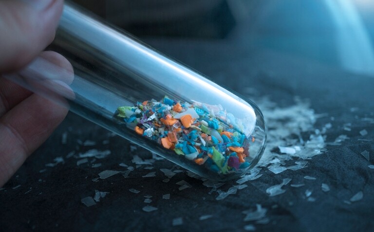 Multicoloured microplastics inside a glass lab test tube to illustrate the finding that microplastics change gut microbiome composition