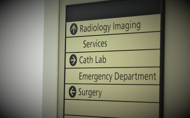 A directional sign in a hospital pointing to Radiology imaging service straight ahead