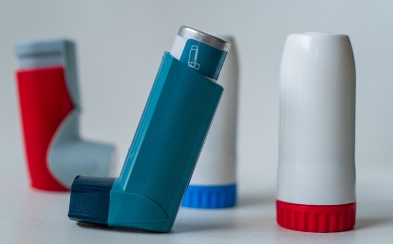 A selection of four inhalers with salbutamol and budesonide-formoterol in the foreground to illustrate the redefining of paediatric asthma treatment based on Professor Andy Bush's research