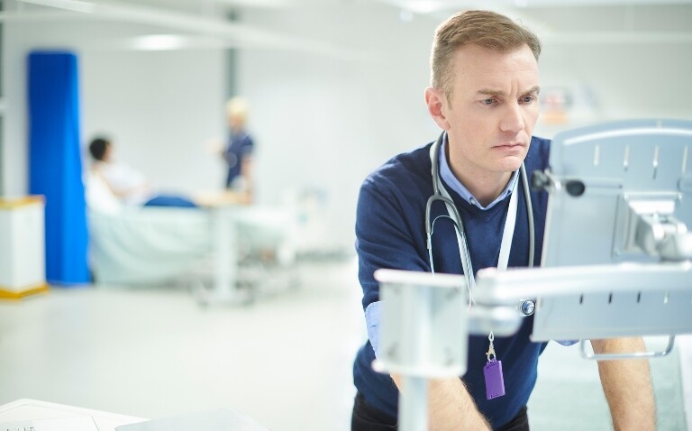 A doctor looking at a computer screen on a hospital ward to illustrate the fact that reliance on rapid molecular diagnostics for prescribing decisions about antibiotics in intensive care units has been found to be inadequate
