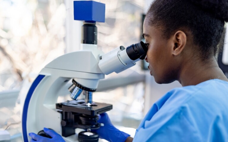 Healthcare professional looking at bacteria samples under a microscope in a laboratory to illustrate that a UKHSA study has identified some bacteria have already become resistant to the ceftazidime/avibactam antibiotic