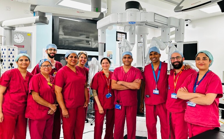Mr Vanash Patel and his colleagues at West Hertfordshire Teaching Hospitals NHS Trust standing in front of their rabot for colorectal cancer robotic surgery
