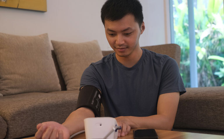 Picture of man measuring blood pressure to depict different hypertension risk in South and East Asian people