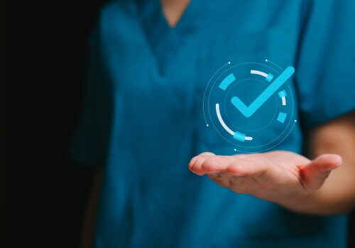 A close-up of a medic wearing scrubs with their hand outstretched and an illustration of a tick in a circle sitting above their palm to illustrate the finding that lutikizumab delivers clinically meaningful improvements in refractory hidradenitis suppurativa