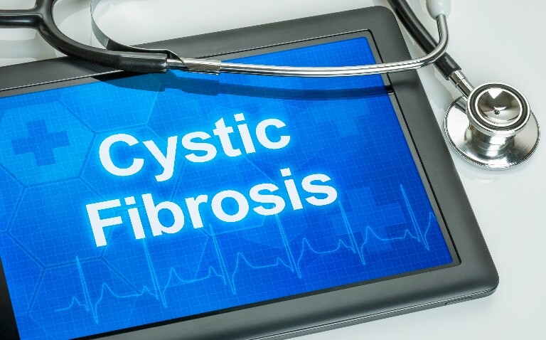 A tablet device with the words cystic fibrosis in white on a blue background and a stethoscope over the top to illustrate a Clinical Excellence in Respiratory Care session on cystic fibrosis after CFTR modulators and the evolution of adult services
