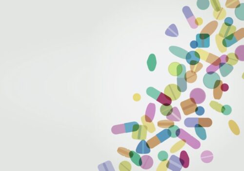 Abstract illustration of colourful pills and capsules scattered diagonally across a light background to illustrate that switching medicine formulation for children has significant cost savings