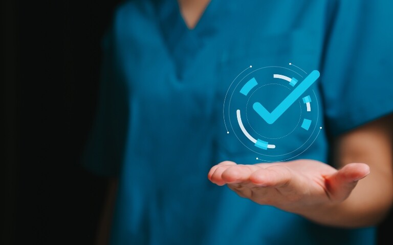 A close-up of a medic wearing scrubs with their hand outstretched and an illustration of a tick in a circle sitting above their palm to illustrate the finding that lutikizumab delivers clinically meaningful improvements in refractory hidradenitis suppurativa