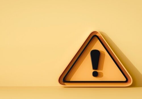 A yellow triangle with a black outline and a black exclamation mark in the centre on a yellow background to illustrate a new pharmacy safety campaign for HMPs