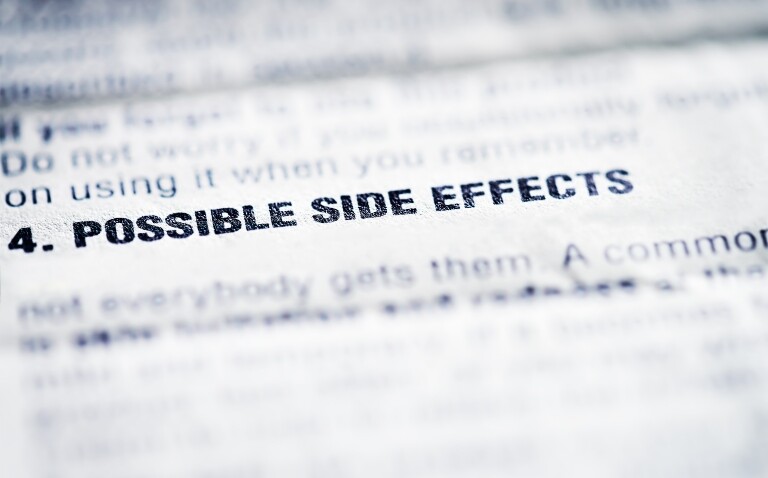 Close-up on the words 'Possible side effects' on a patient information leaflet to illustrate the suggestion that statins health information revisions are required after a study found limited side effect causation