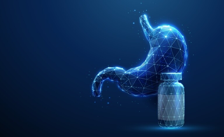 Abstract blue human stomach next to a medicine bottle to illustrate the finding that long-term PPI use may not increase gastric cancer risk as previously thought