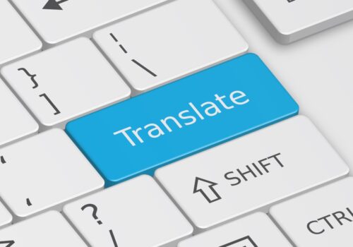 The word Translate written on a blue key on a white keyboard to illustrate the finding that bilingual consent forms boost SACT understanding in patients with limited English proficiency