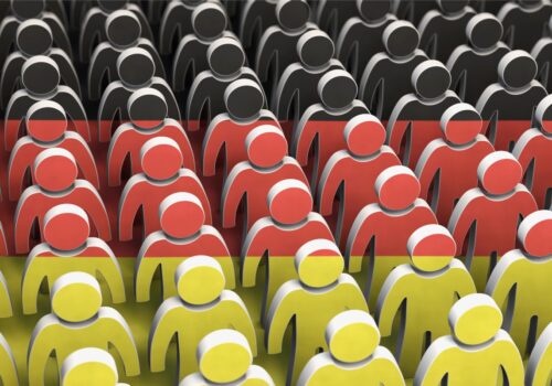 Rows of stylised human figures coloured black, red and yellow in stripes to represent the German flag to illustrate the question of whether population screening for melanoma skin cancer reduces mortality
