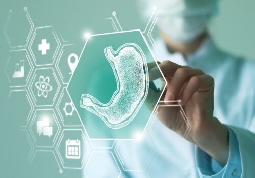 A healthcare professional interacting with a digital medical interface displaying an illustrated stomach and healthcare icons, symbolising gastrointestinal treatment, bariatric surgery and obesity management to illustrate the finding that semaglutide delivers substantial weight loss after suboptimal bariatric surgery response